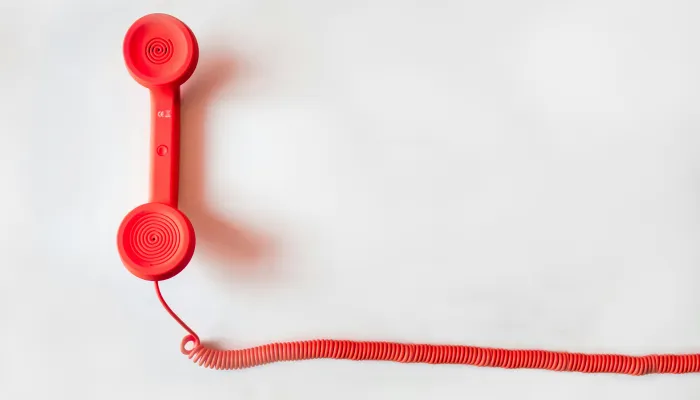 a red telephone handset from an old fashioned house phone