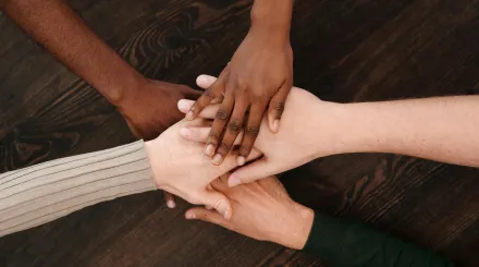 five hands placed on top of each other