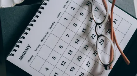 a page from a monthly calendar, with some glasses sitting on top