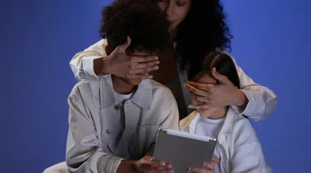 Woman covering children's eyes